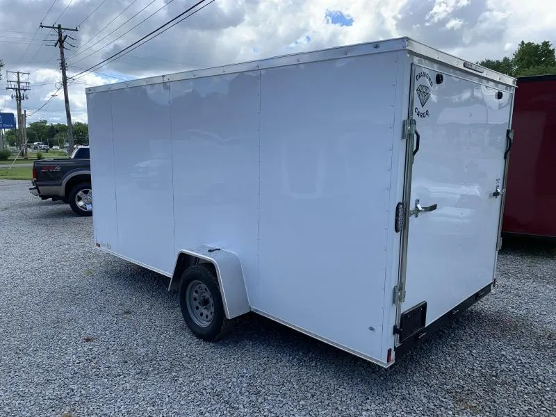 7x14 enclosed trailer loaded with landscaping mowers and trimmer racks