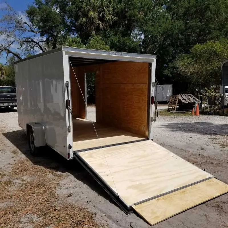 White 7x14 enclosed tandem axle trailer with rear ramp door