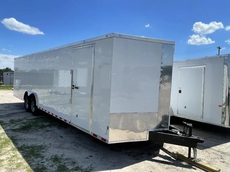 Tandem axle close-up on an 8.5x28 enclosed trailer showing durable running gear