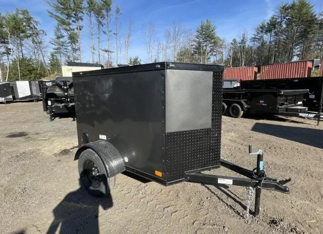 Front view of a blackout enclosed cargo trailer with V-nose design