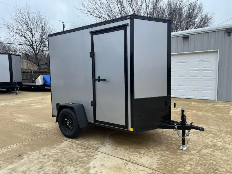 Side profile of a blackout enclosed trailer with black trim and black wheels