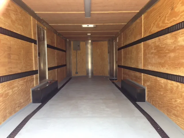 Interior of an enclosed cargo trailer with E-track tie-down system for securing cargo