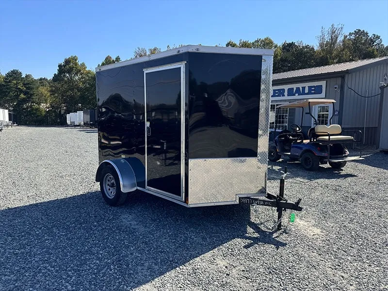 Rear barn doors on a compact enclosed trailer for quick cargo access