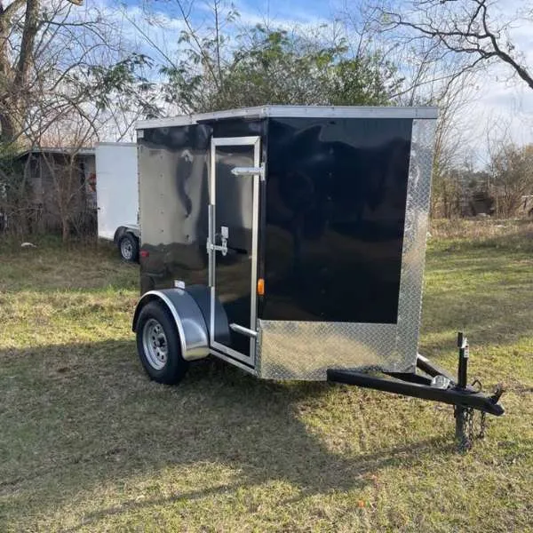 Enclosed cargo trailer equipped with torsion axles parked outdoors (hero image)